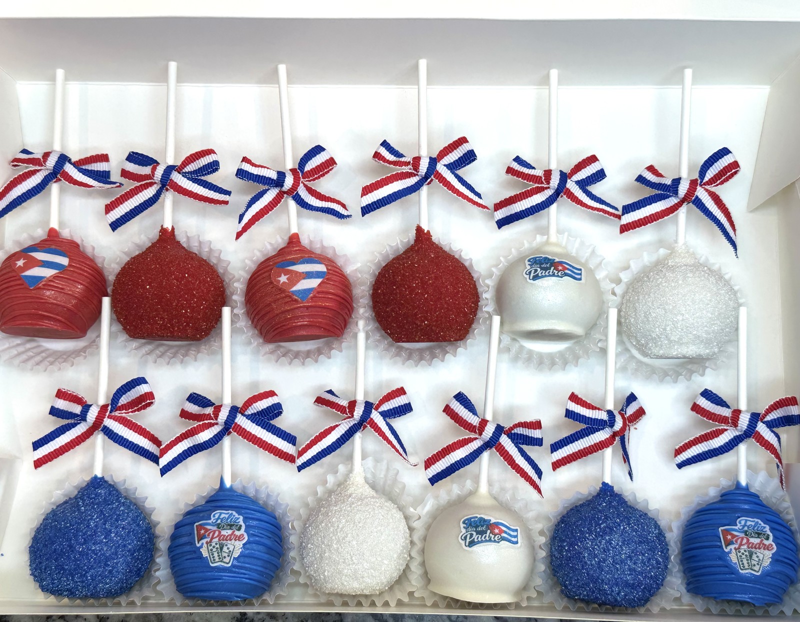 Red, white, and blue Cuba themed cake pop collection with ribbon bows