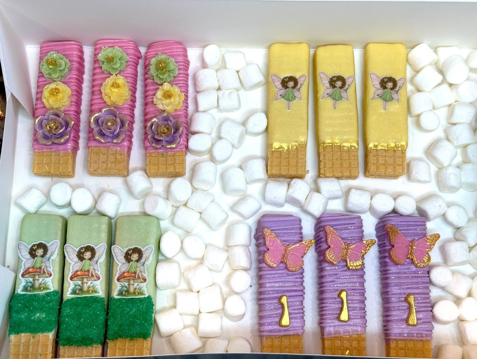 Custom dipped wafer sticks with edible fairy images and flowers by Heavenly Dipped Delights