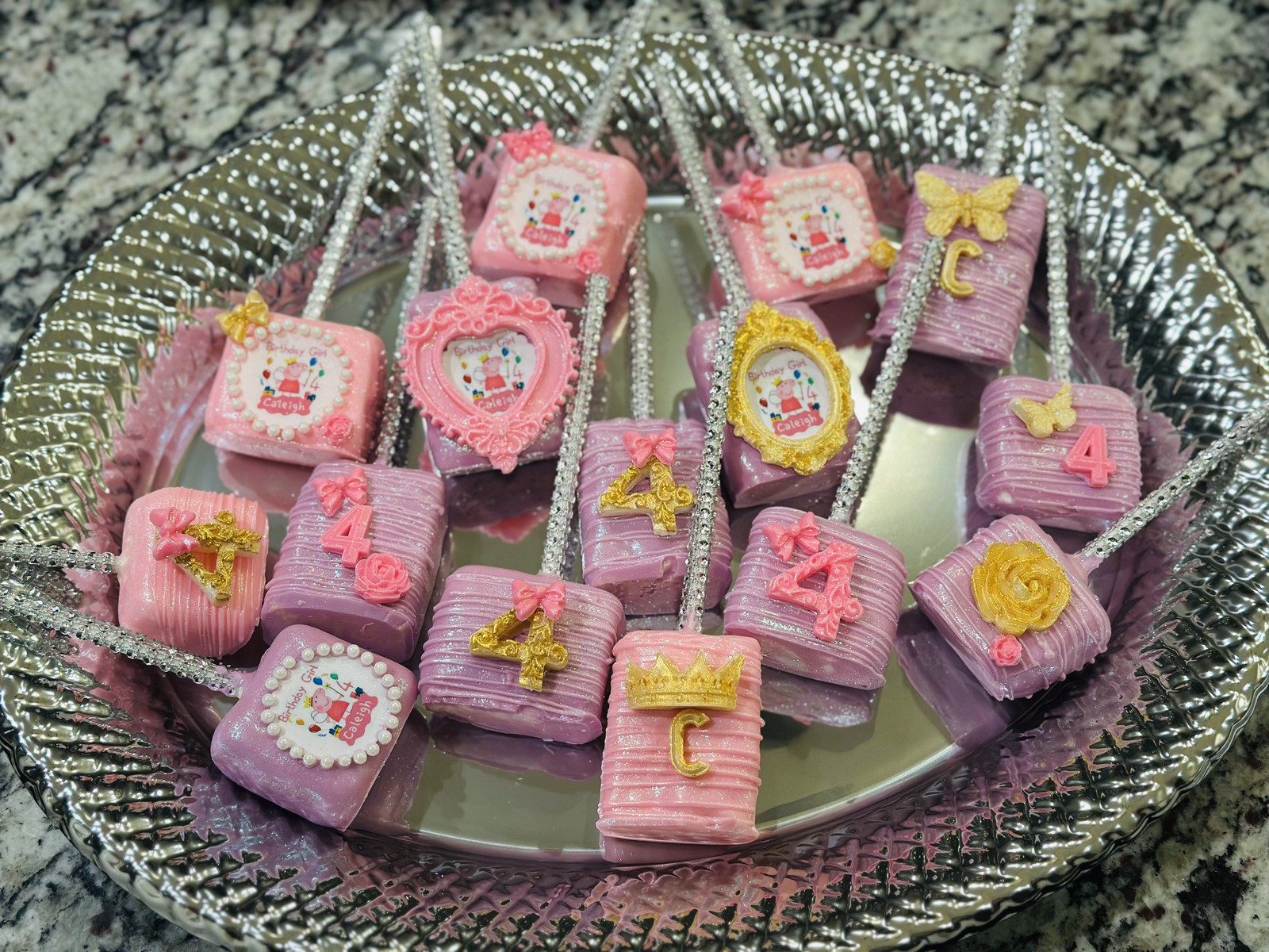 Pink and purple princess birthday chocolate covered marshmallows with ornate frames, crowns, butterflies, and rhinestone sticks
