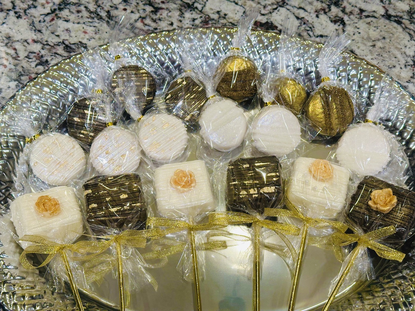 Elegant black, white, and gold chocolate covered marshmallow assortment with roses and metallic finishes