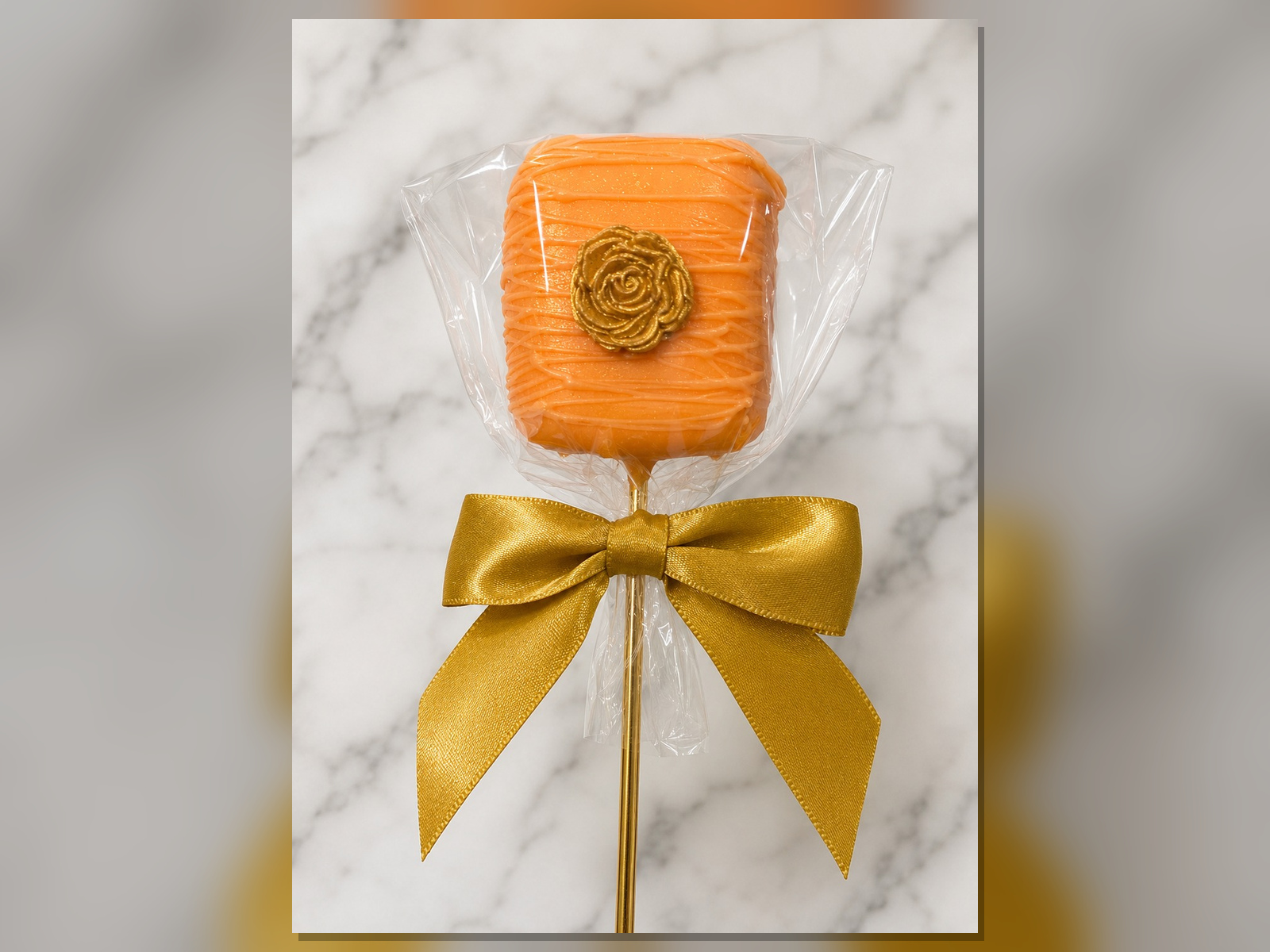 Orange chocolate covered marshmallow with gold bow by Heavenly Dipped Delights