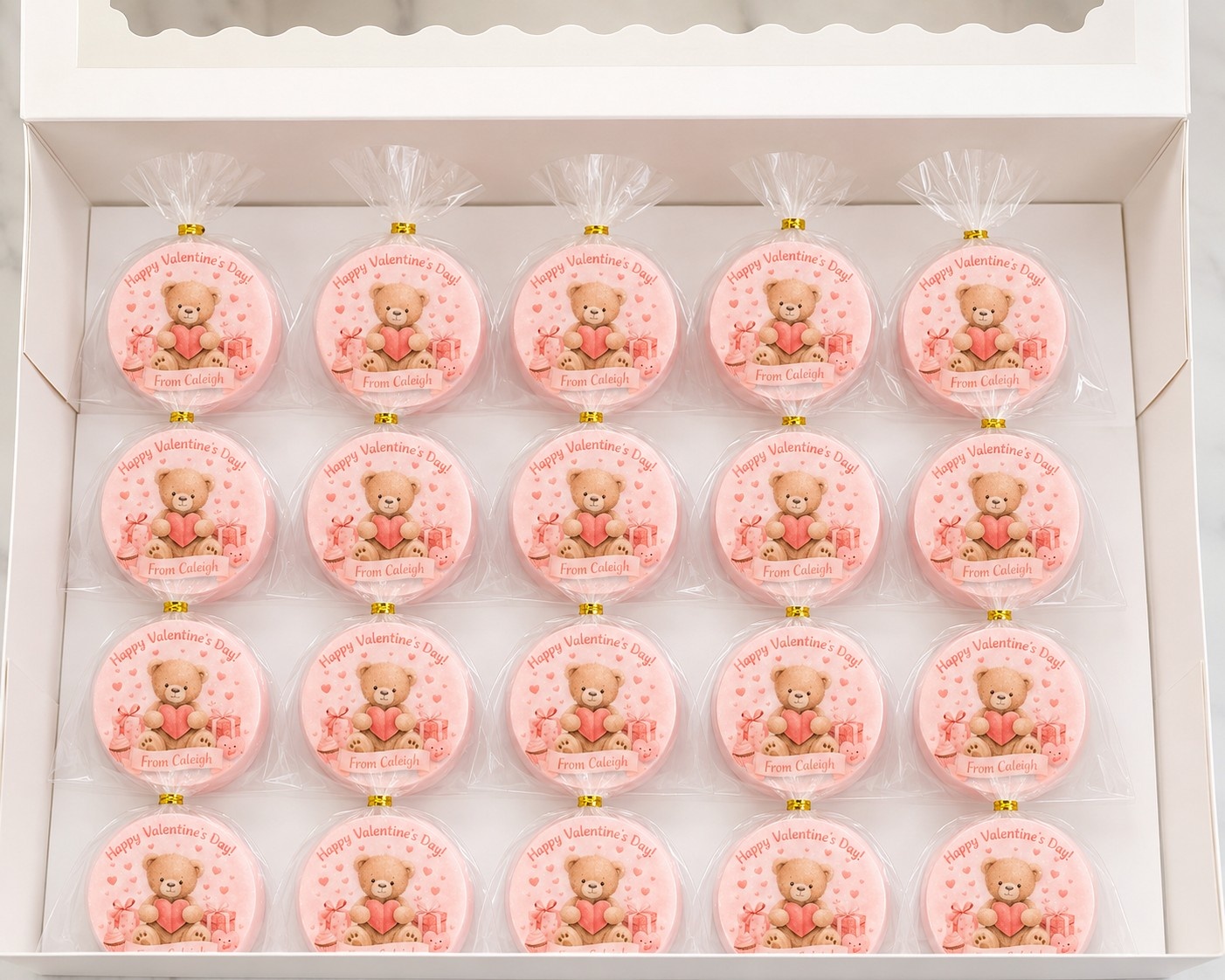 Personalized pink Valentine teddy bear chocolate covered Oreos individually wrapped and displayed in a gift box