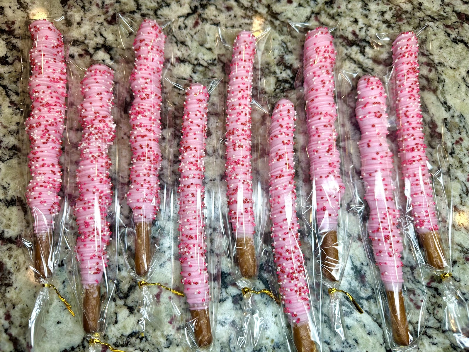 Elegant sage, ivory, and gold chocolate covered pretzels with bees and honeycomb details