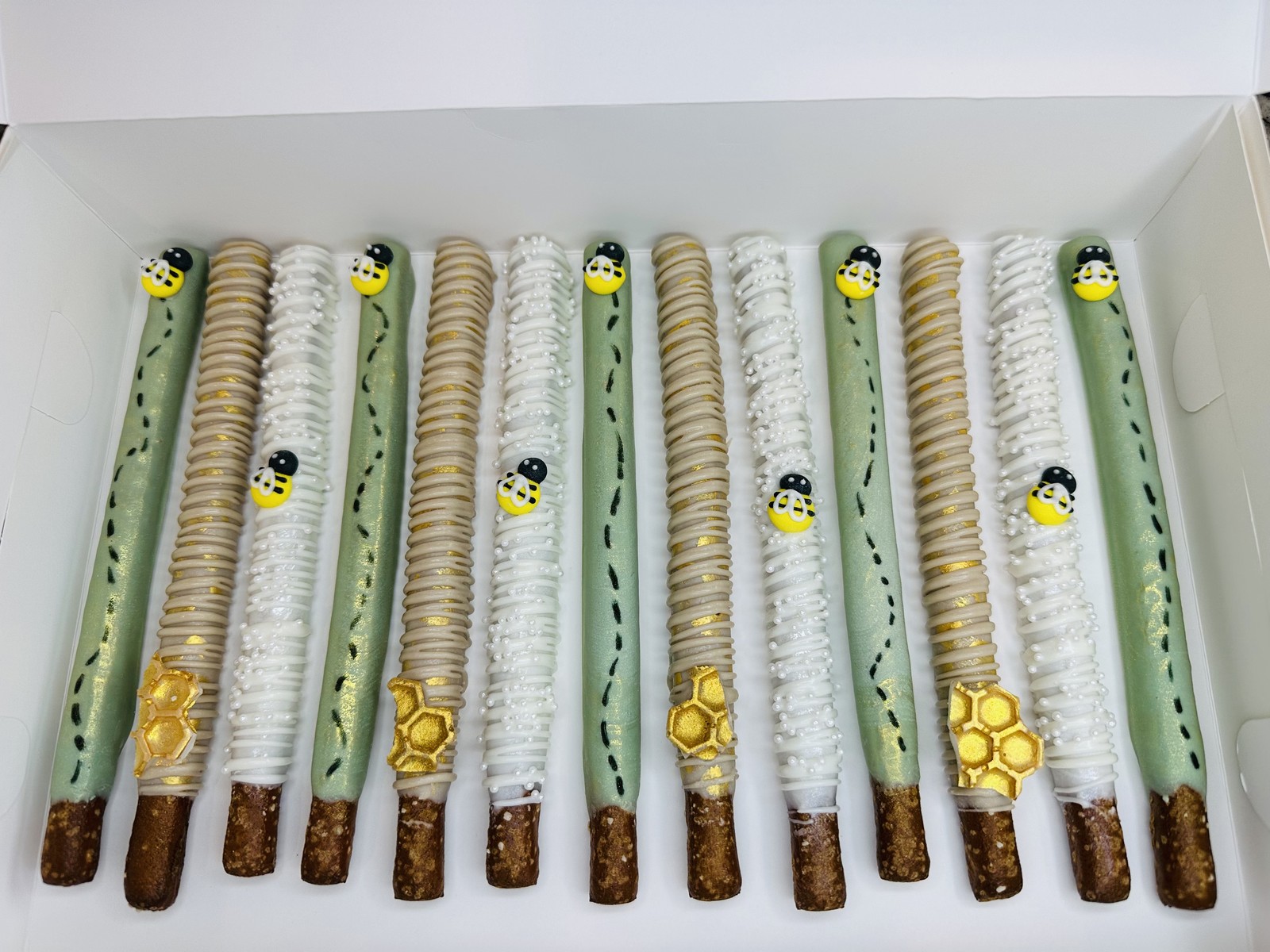 Gold, coral, and blue glitter chocolate covered pretzel rods