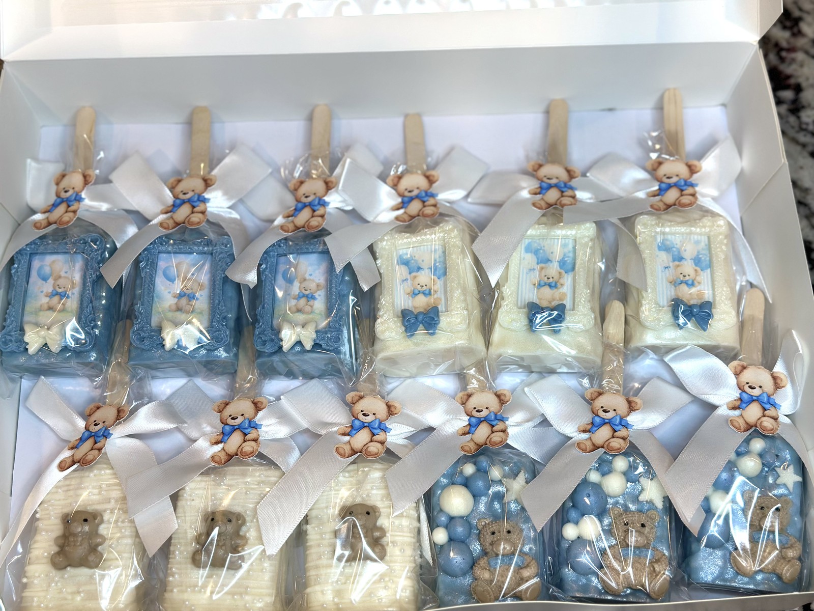 Blue and white teddy bear chocolate covered Rice Krispie treat collection with bows, framed designs, and bubble details