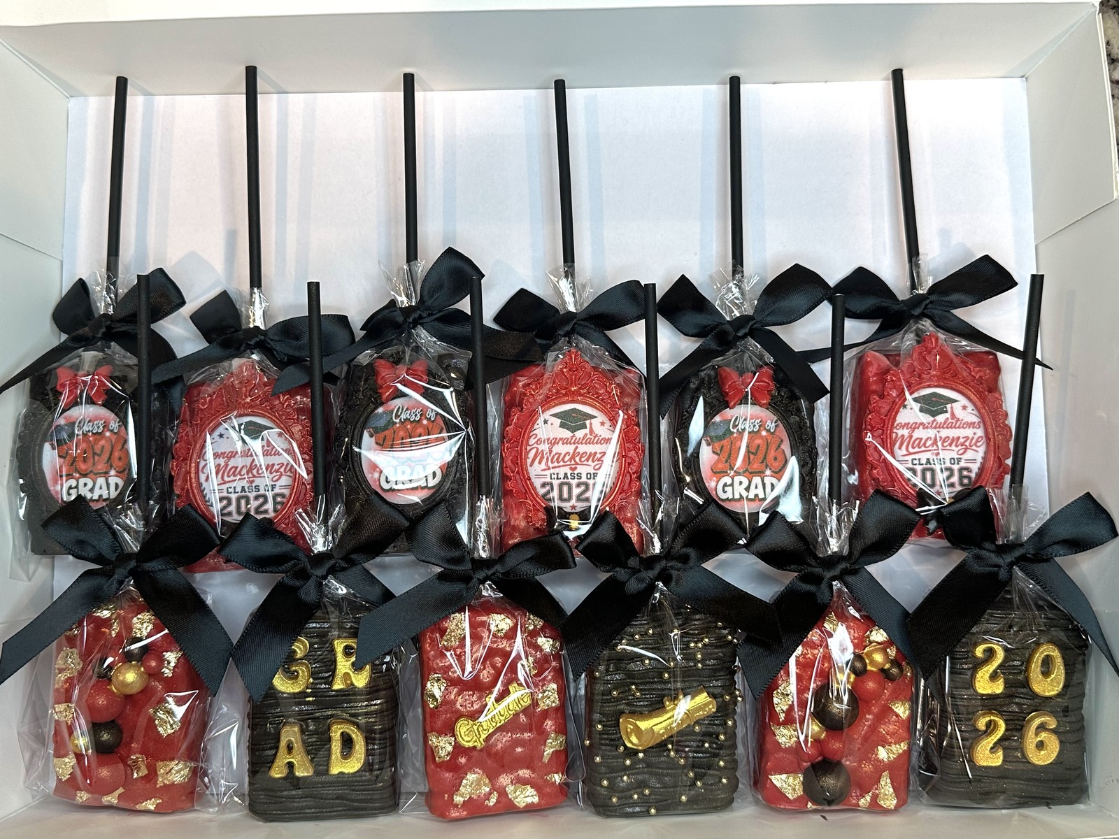 Red and black graduation chocolate covered Rice Krispie treat collection with gold details and black bows