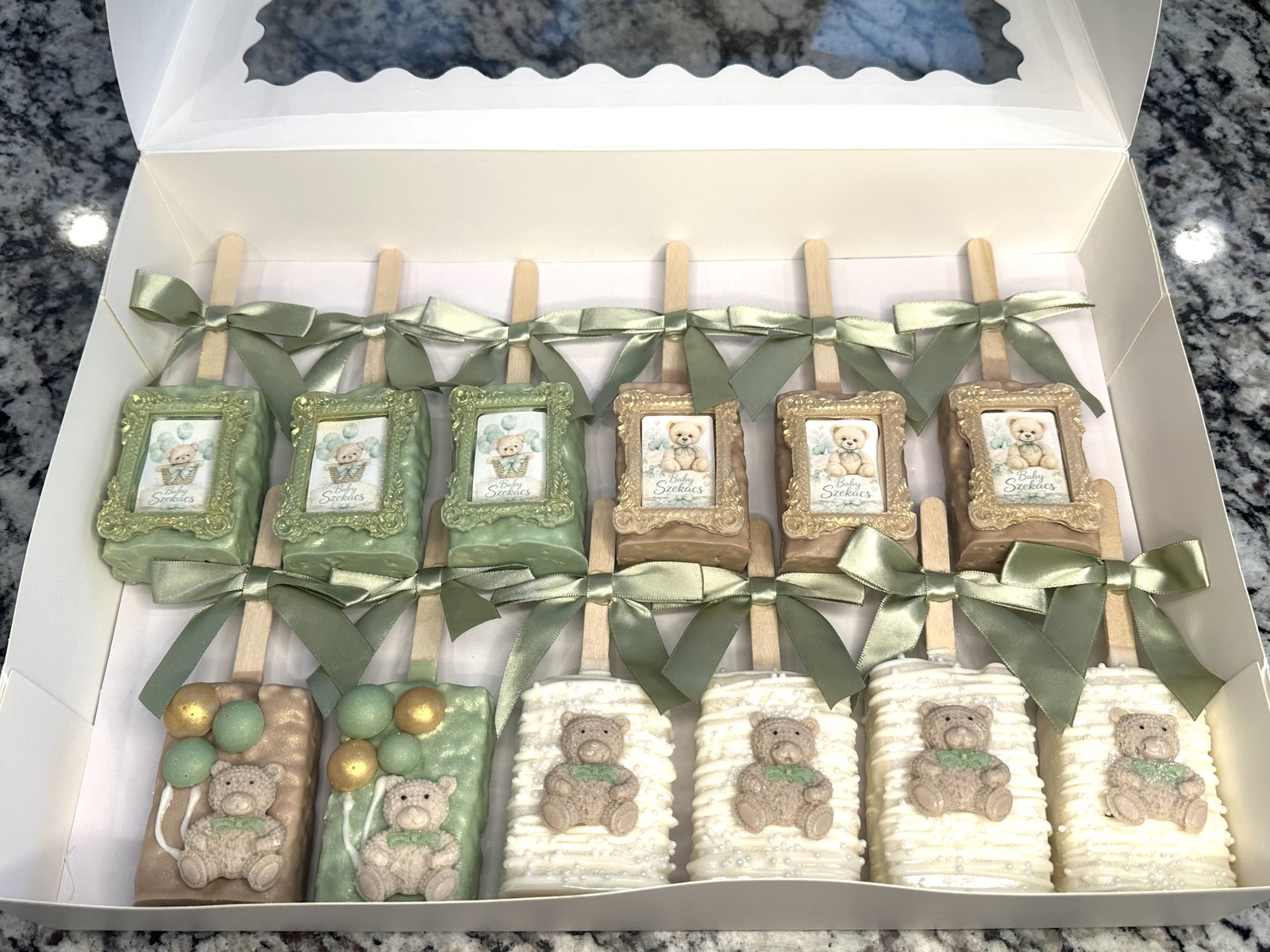 Sage, champagne, ivory, and gold teddy bear chocolate covered Rice Krispie treat collection with satin bows and framed baby details