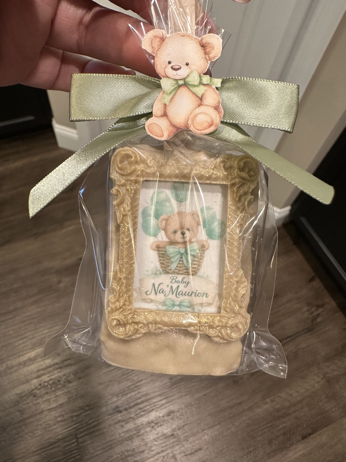 Individually wrapped champagne and gold framed teddy bear chocolate covered Rice Krispie treat with sage bow