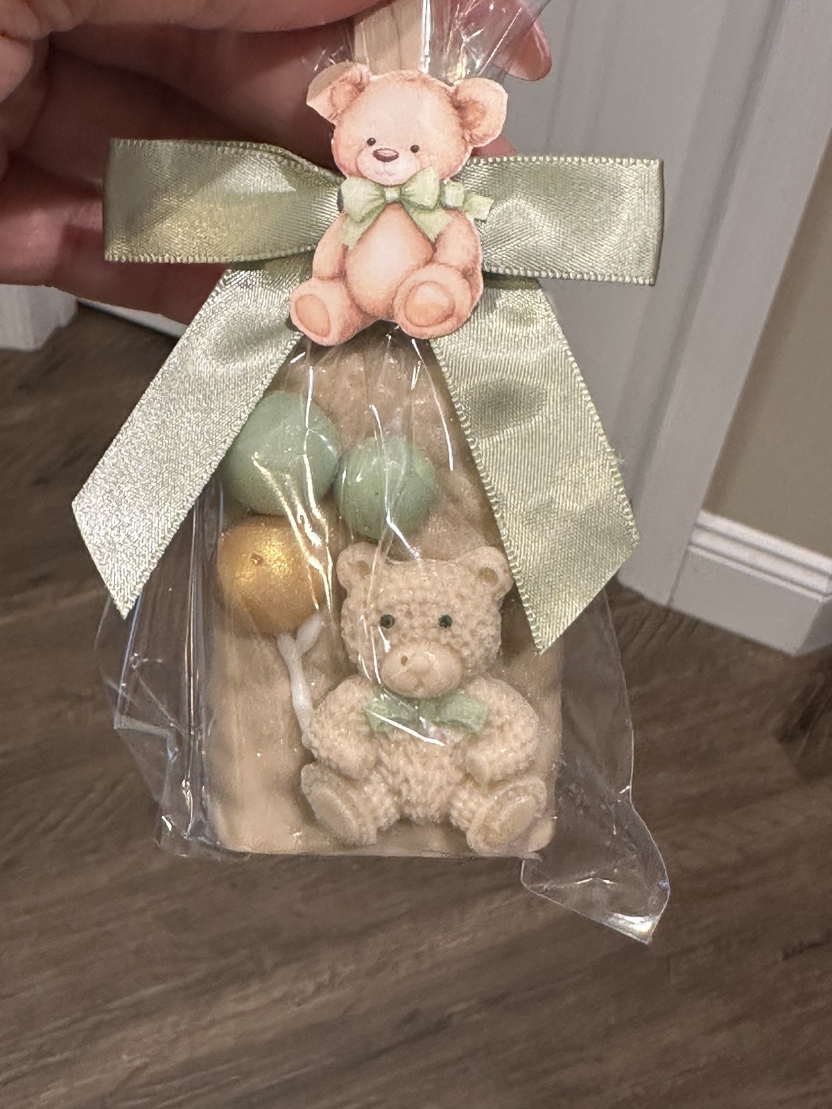 Individually wrapped champagne teddy bear chocolate covered Rice Krispie treat with decorative chocolate bubbles and sage bow