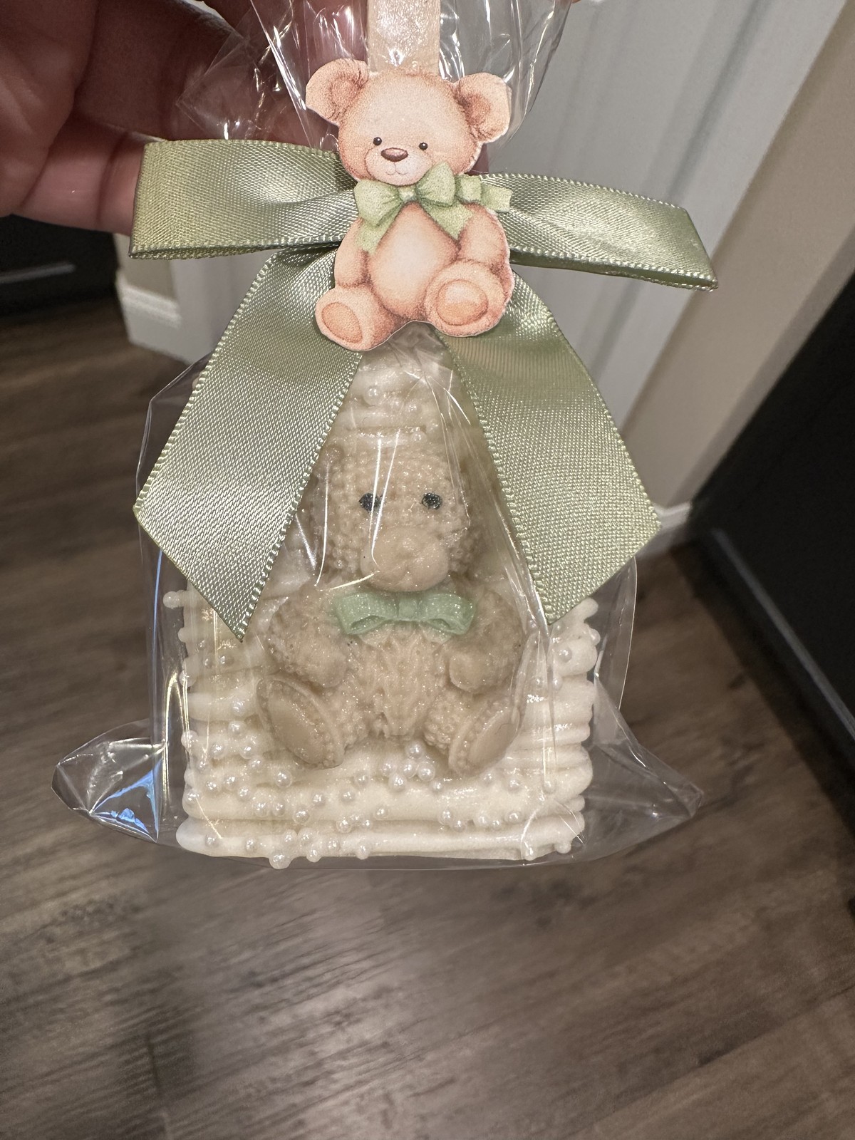 Individually wrapped ivory teddy bear chocolate covered Rice Krispie treat with pearl details and sage bow
