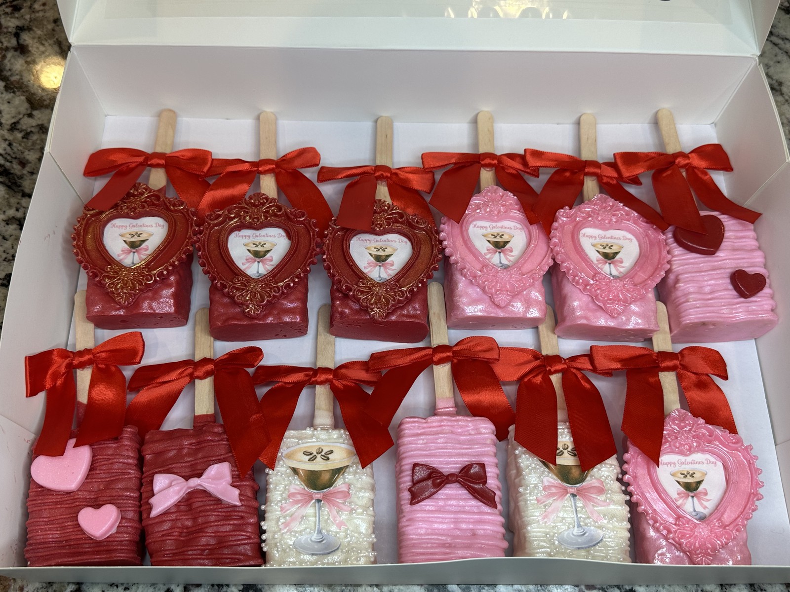 Red, pink, and pearl Galentine's Day chocolate covered Rice Krispie treat collection with bows and ornate heart frames