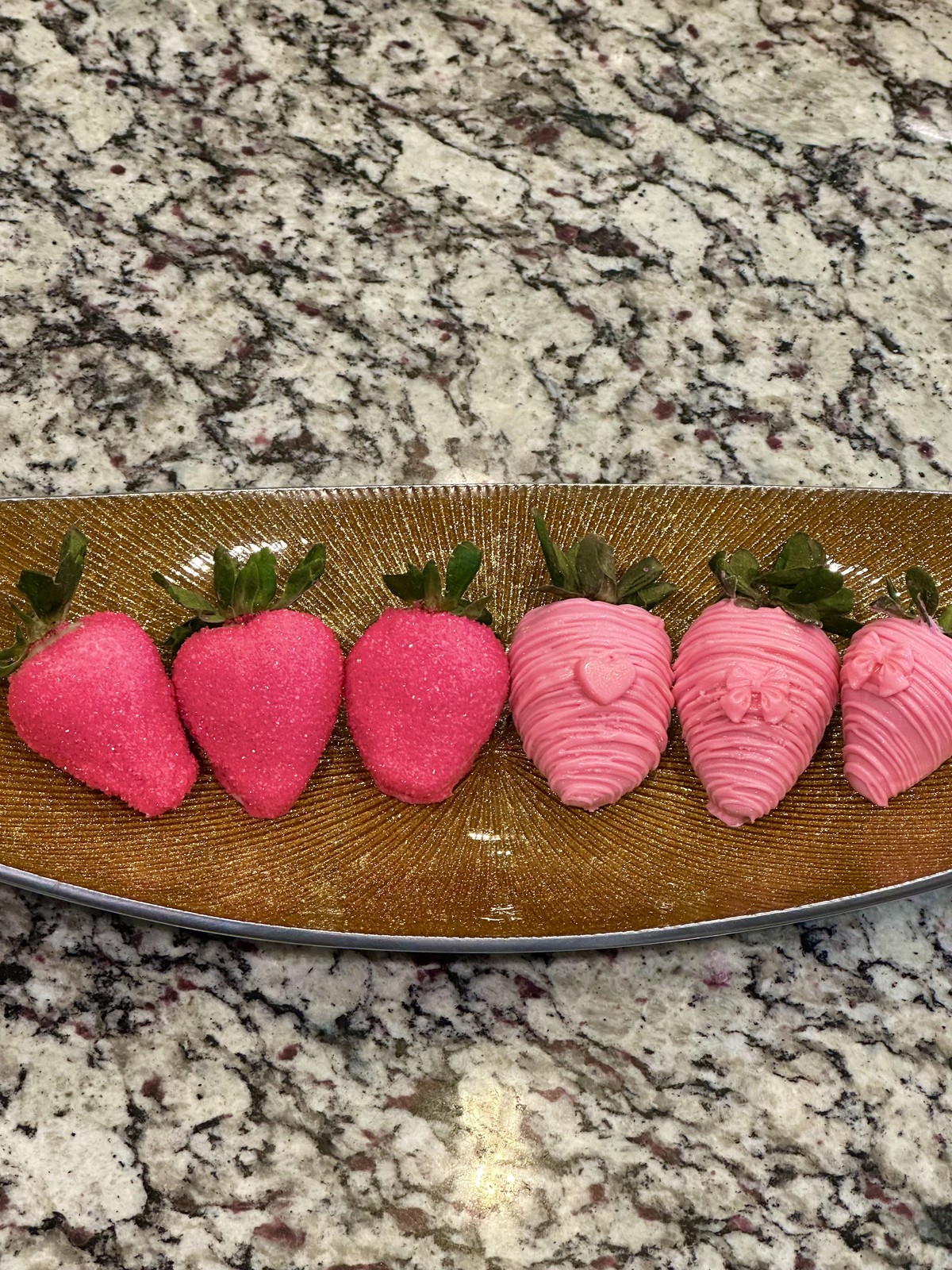 Pink chocolate covered strawberries with sugar crystals and drizzle