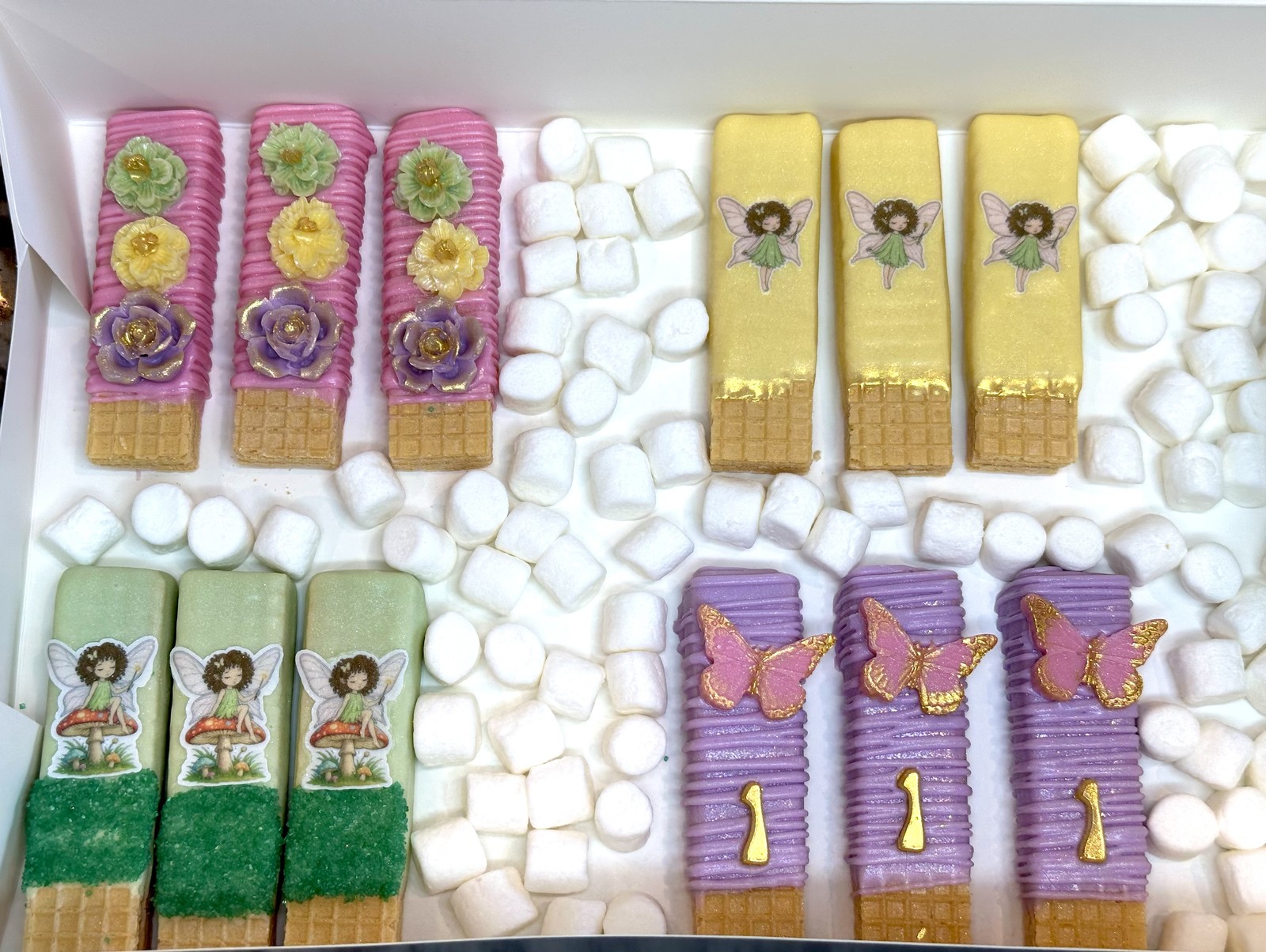 Pastel fairy first birthday dipped wafers with flowers, butterflies, monograms, and marshmallow accents