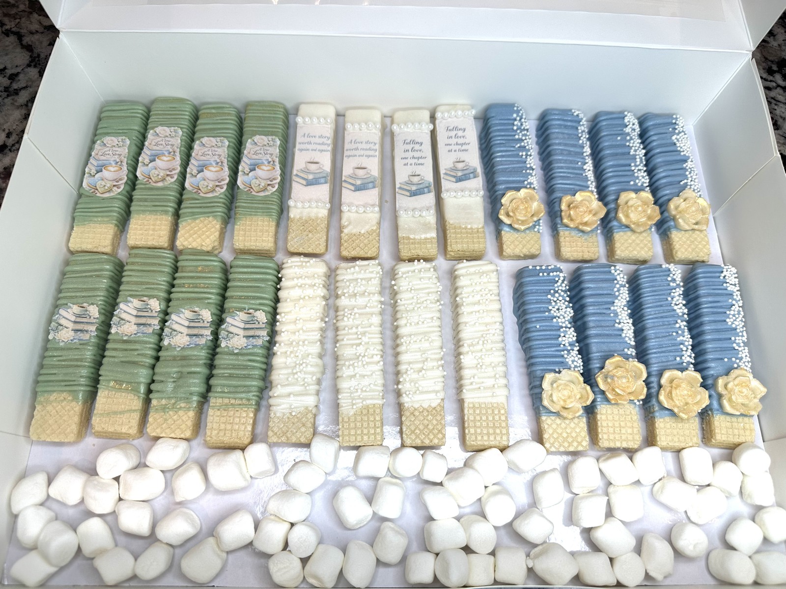 Elegant sage, ivory, and dusty blue dipped wafers with literary designs, pearls, and gold flowers