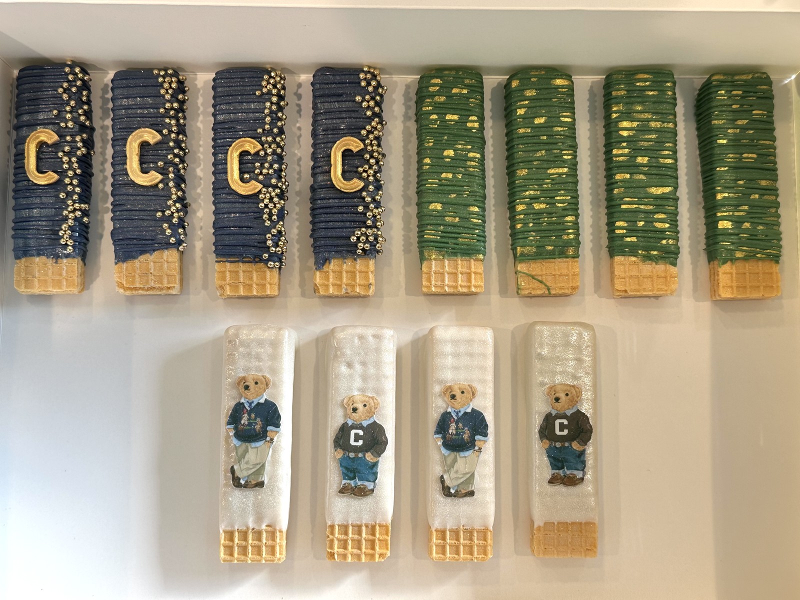 Navy, green, and ivory polo teddy bear dipped wafers with gold monograms and pearl details