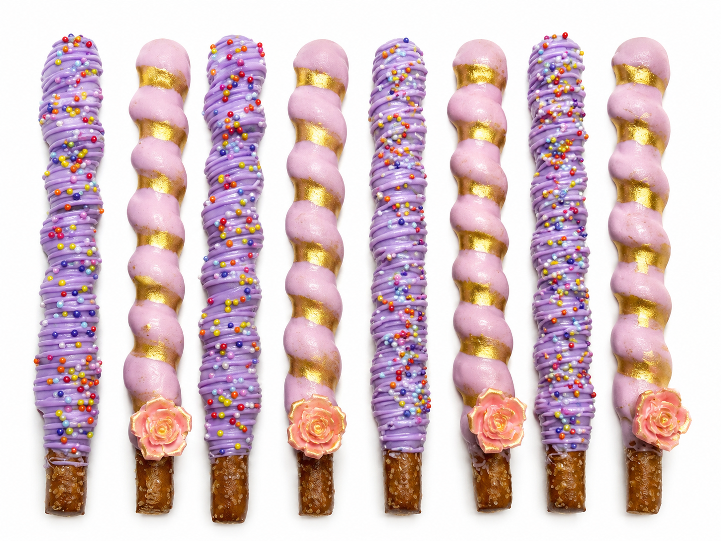 Pink and purple caramel wrapped pretzel rods with gold accents by Heavenly Dipped Delights