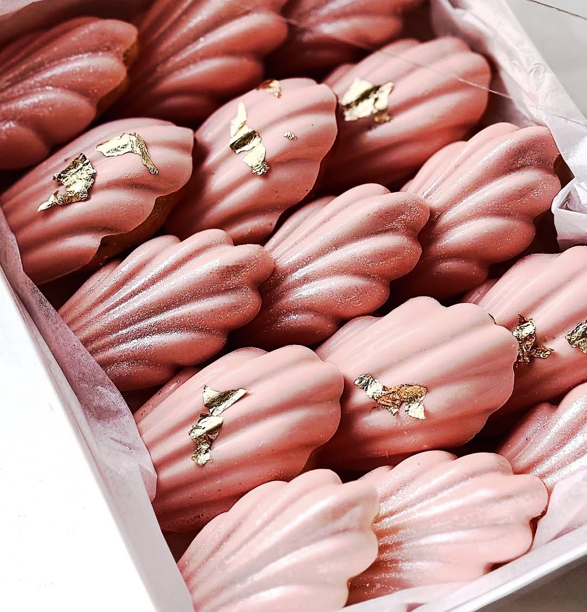 Pink chocolate covered madeleines with gold leaf accents by Heavenly Dipped Delights