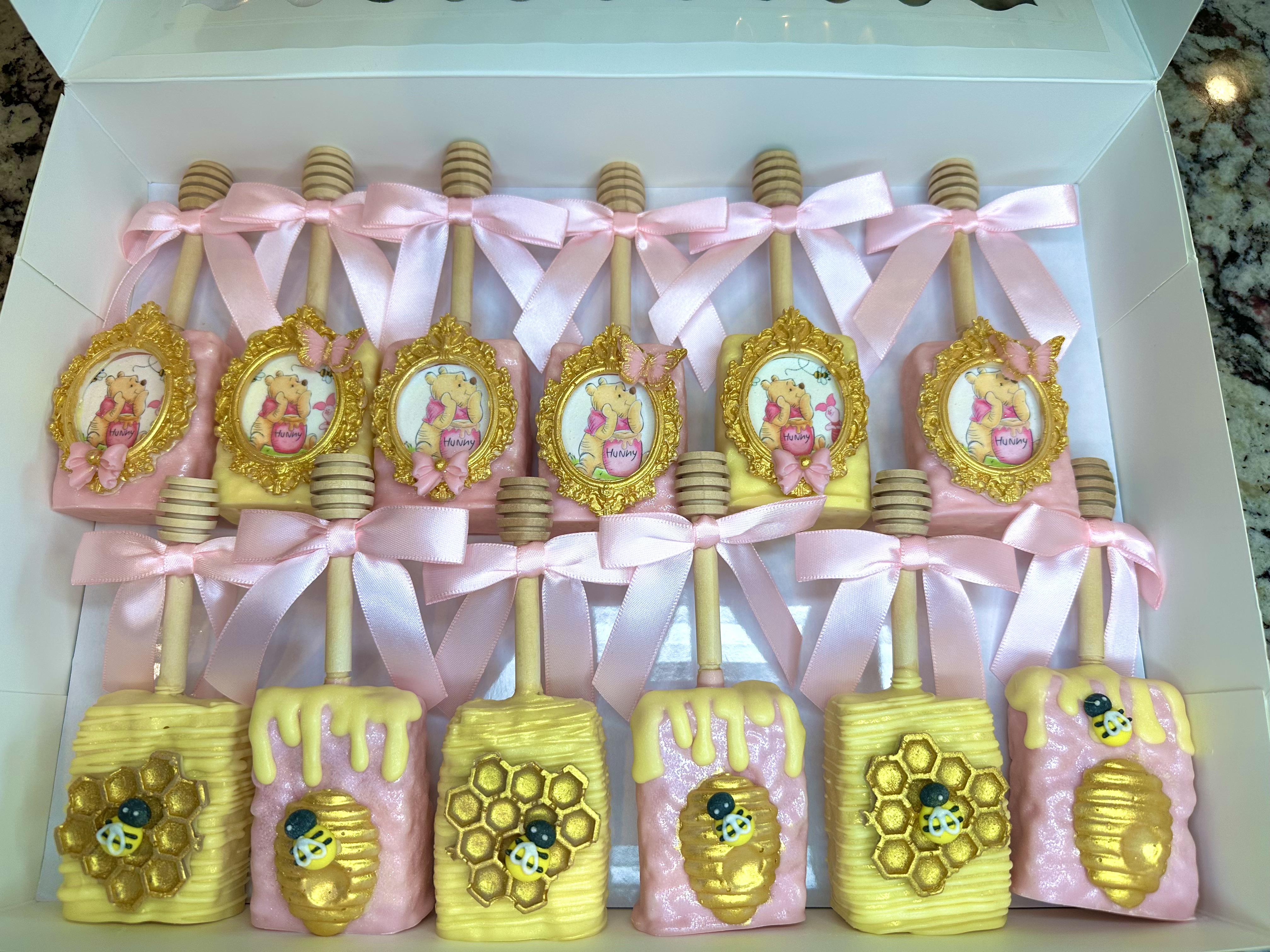 Pink and yellow custom Rice Krispie treats with pink bows by Heavenly Dipped Delights